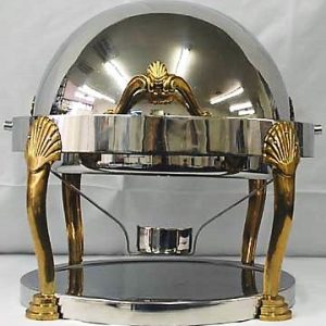 A round chrome and brass chafer with a roll top lid, designed to keep food warm and accessible for large events such as buffets, weddings, and corporate gatherings.